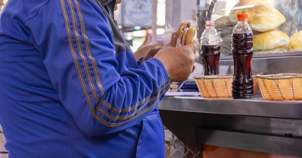 Counter of a Lima huarique with regulars eating ceviche off plastic plates and the cook visible behind the counter