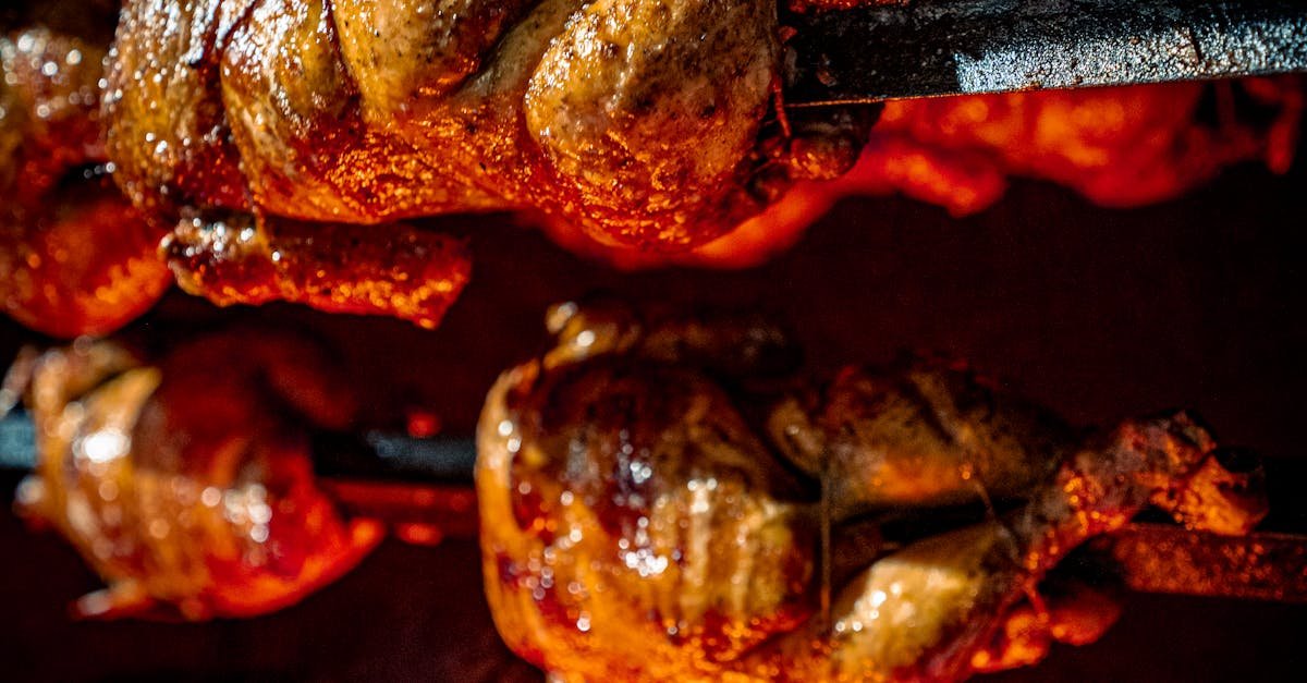 Pollería rotisserie loaded with whole marinated chickens spinning over hot charcoal in a Lima neighborhood restaurant
