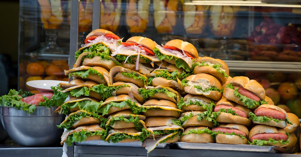 Sangucheria counter in Lima at morning with stacked pan con chicharron sandwiches and a line of weekend customers